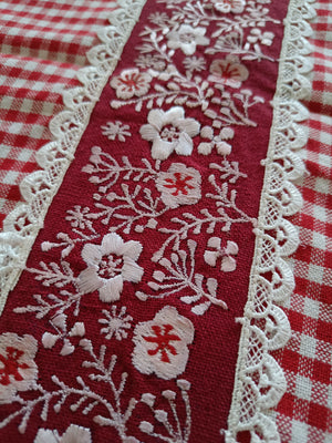 Red floral embroidered table runner with gingham print & lace.