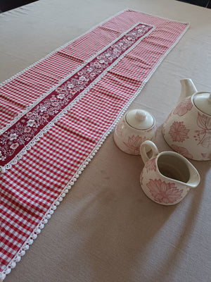 Red floral embroidered table runner with gingham print & lace.