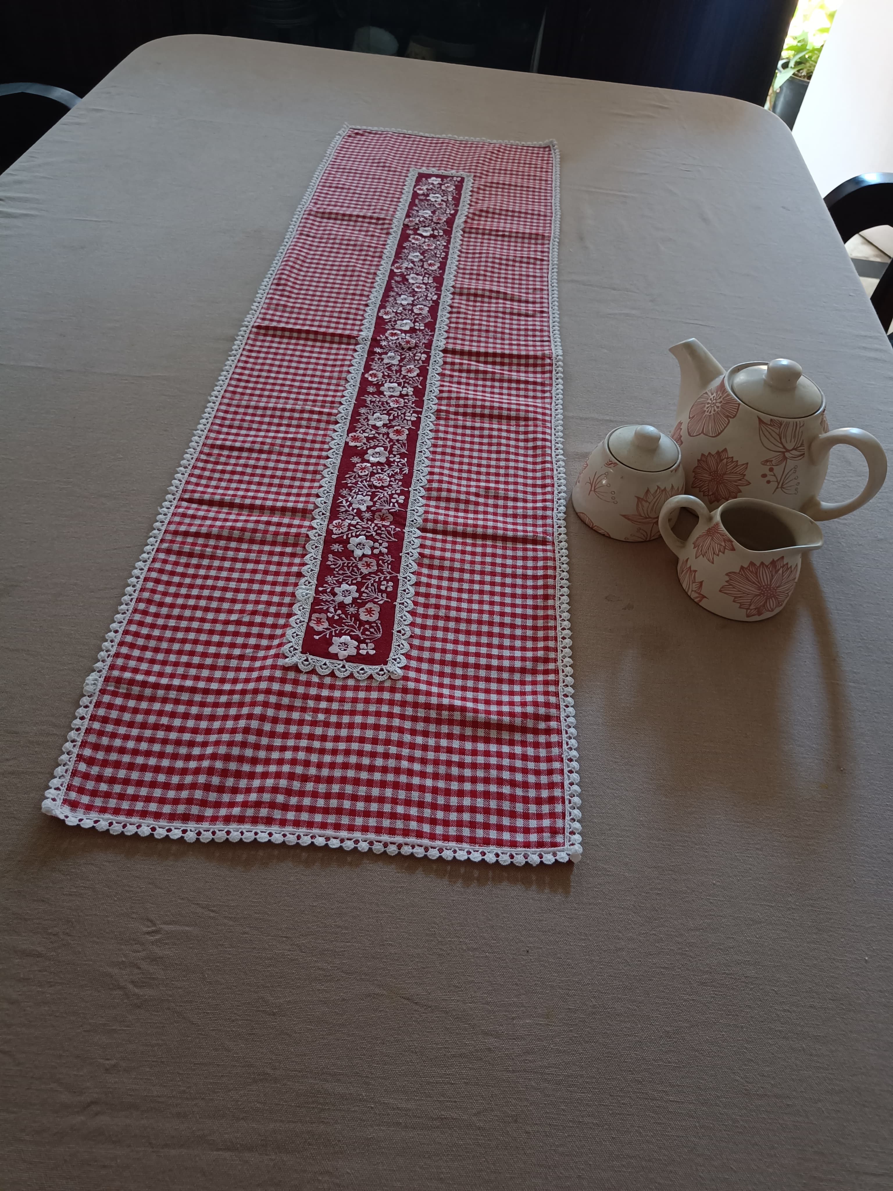 Red floral embroidered table runner with gingham print & lace.