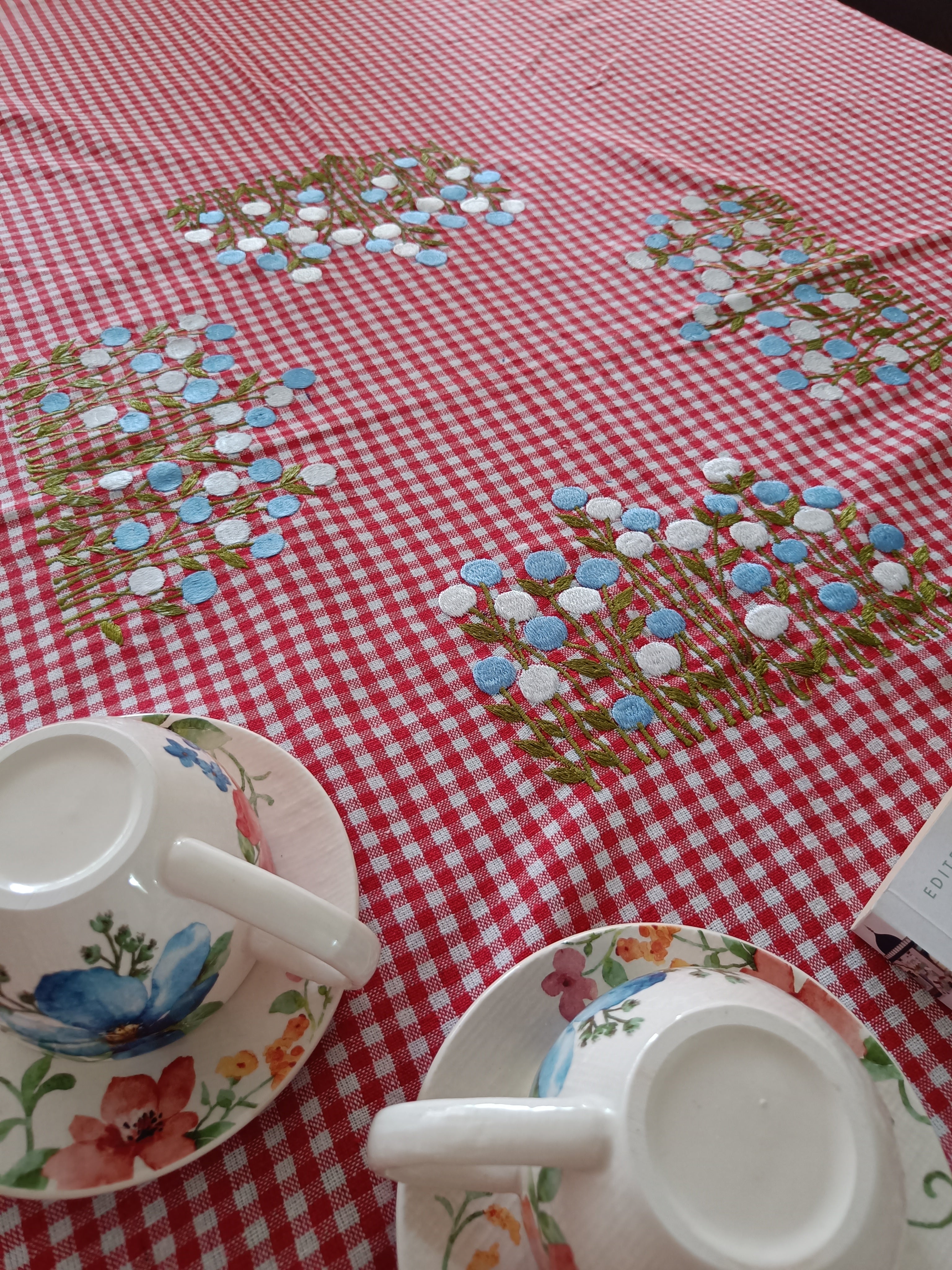 Floral embroidered table cloth in red gingham print