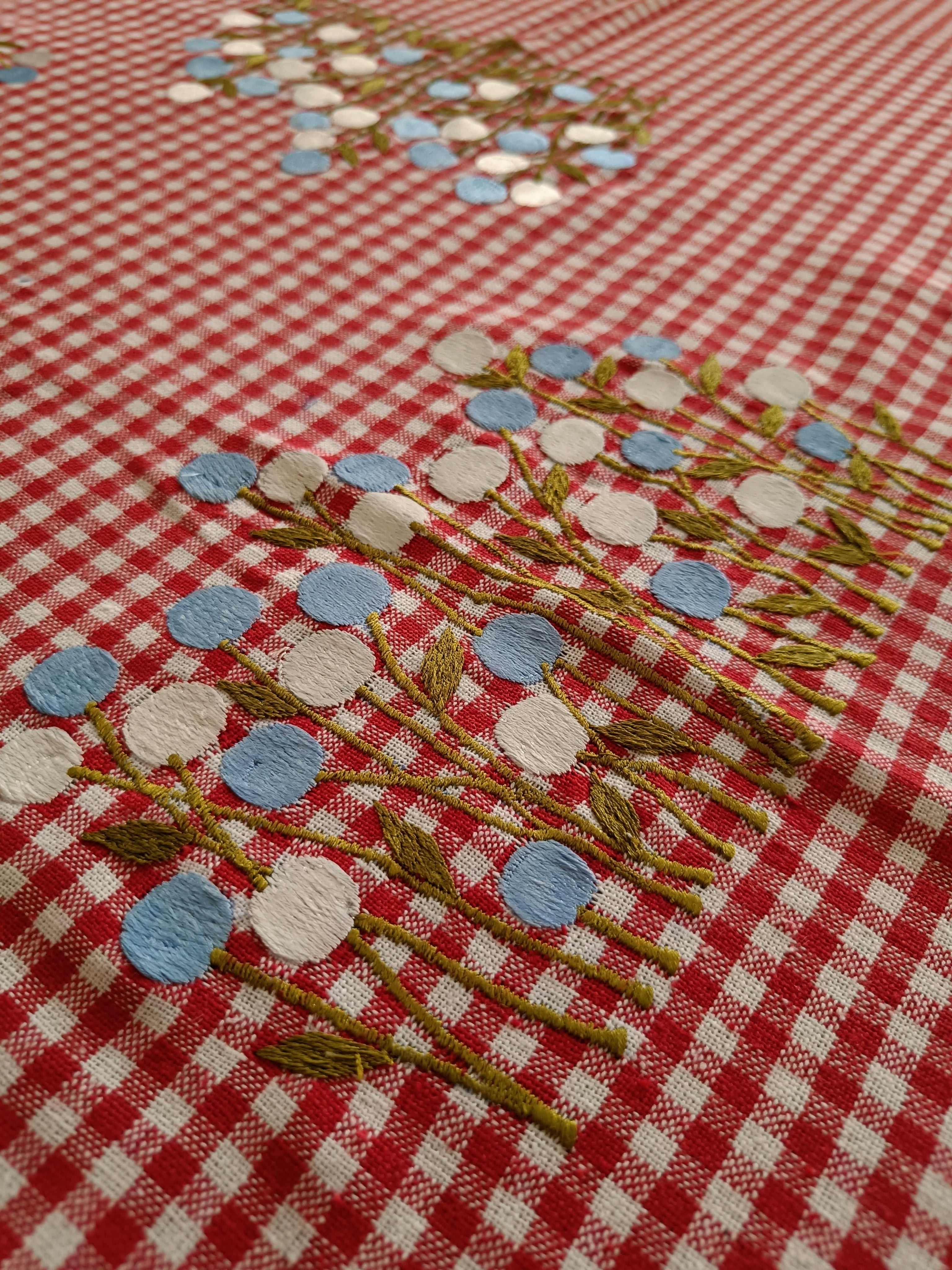 Floral embroidered table cloth in red gingham print