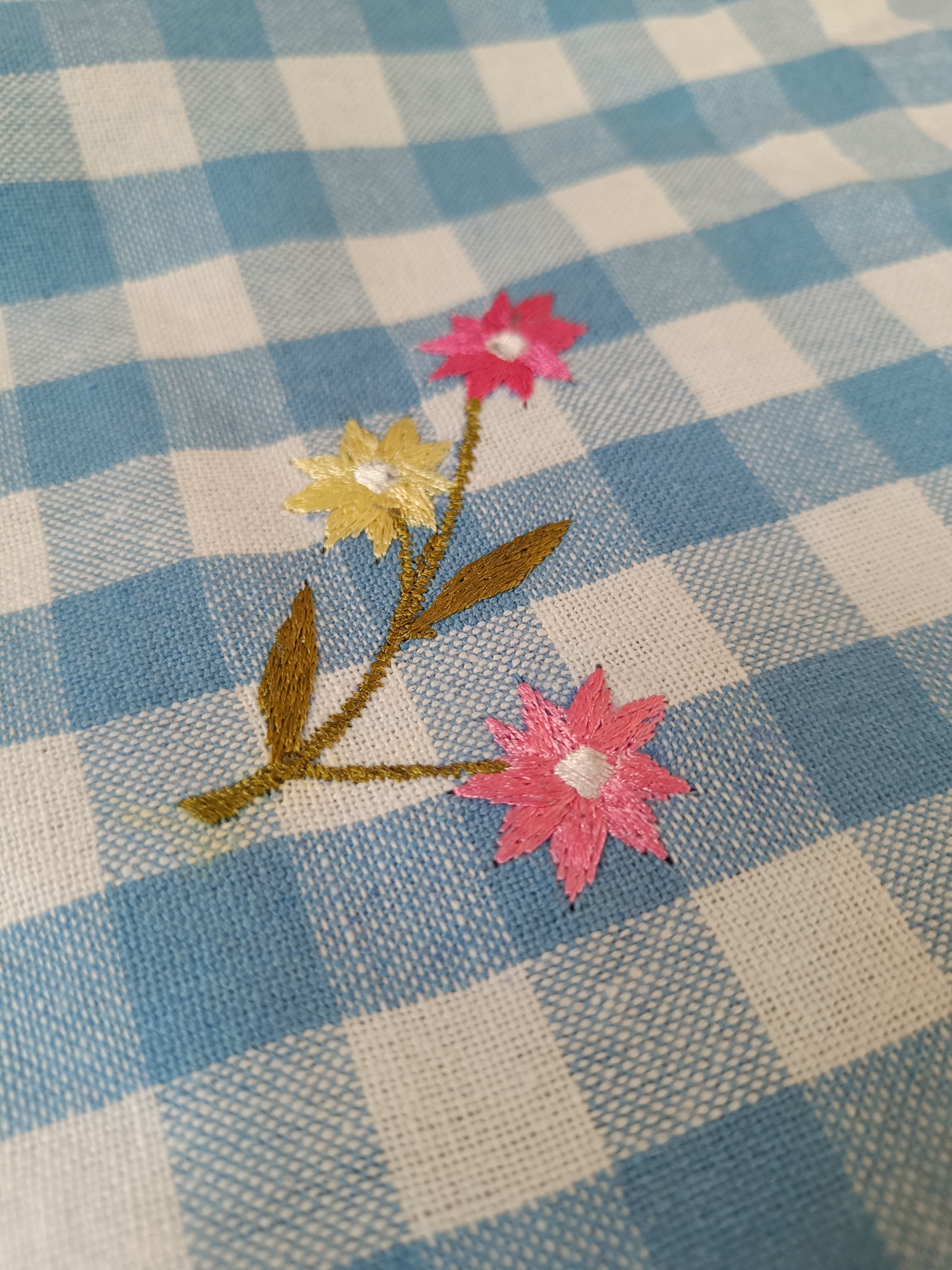 Floral embroidered tablecloth in blue gingham print