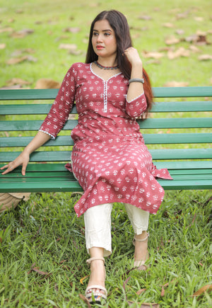 Brick red printed kurta with lace details and pocket.
