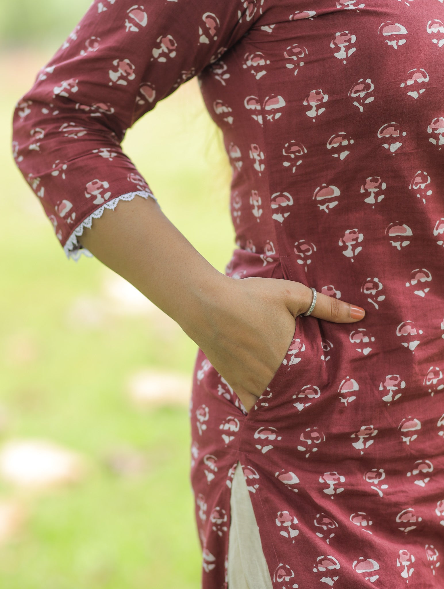 Brick red printed kurta with lace details and pocket.