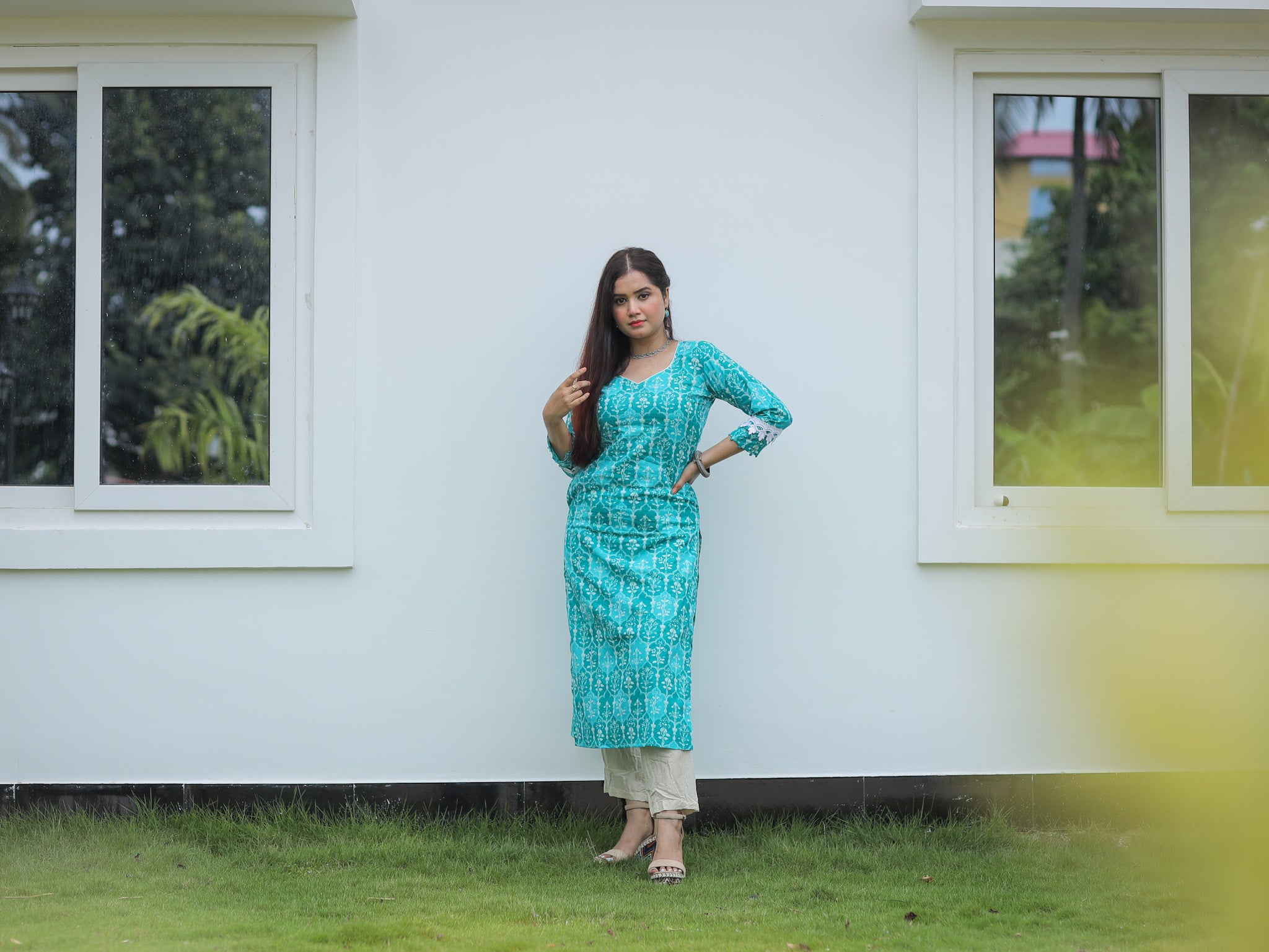 Turquoise green printed kurta with lace details and pocket.