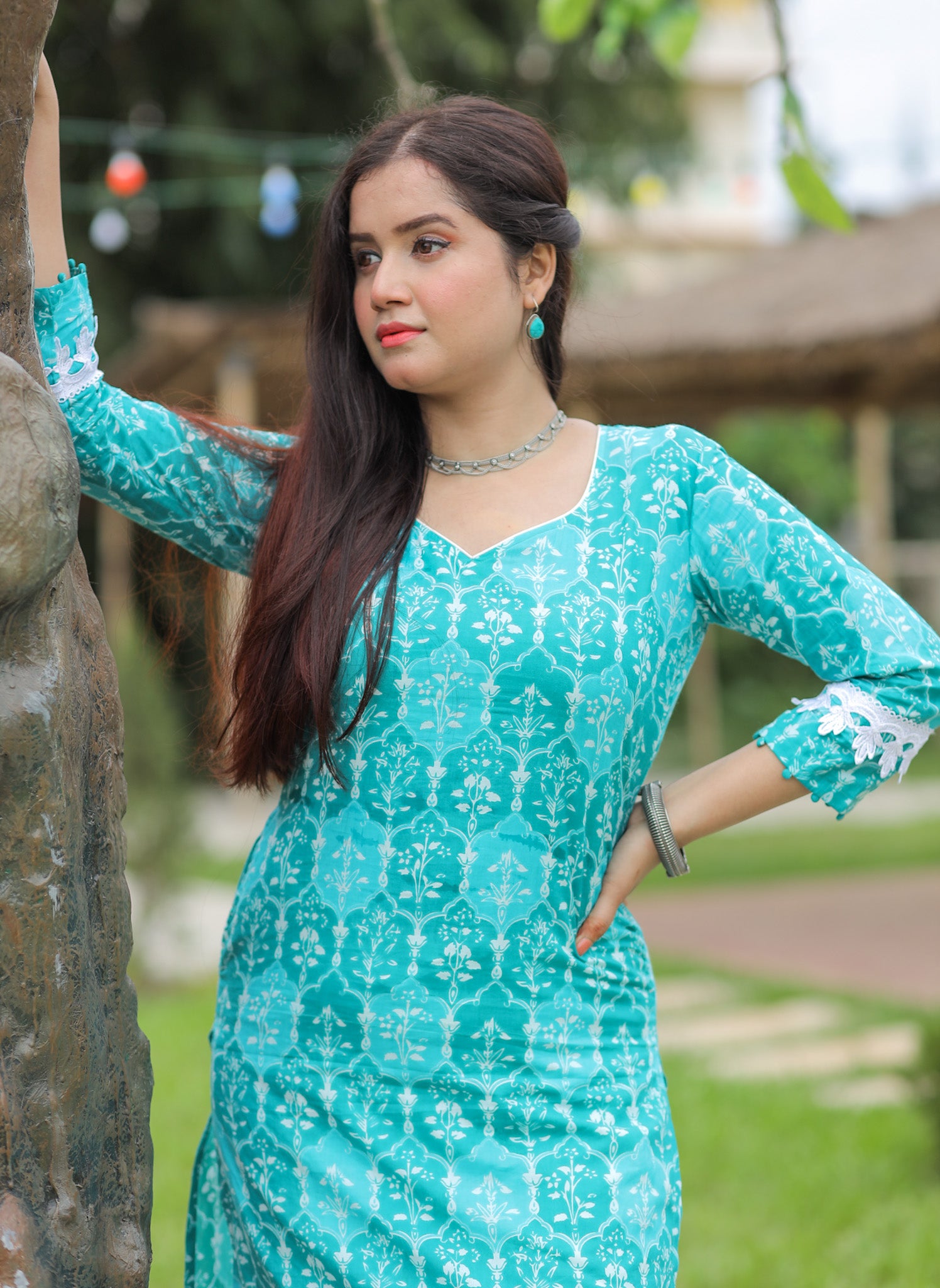 Turquoise green printed kurta with lace details and pocket.